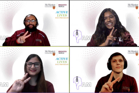 four students on Zoom giving peace signs with their hands.