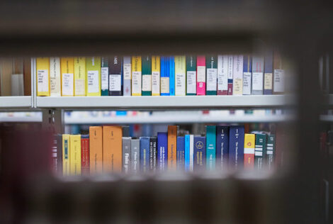 a row of books on a shelf at the library.