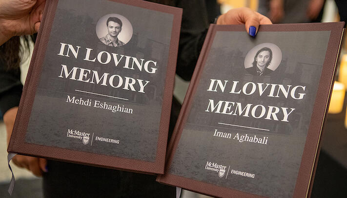 two books in loving memory of Mehdi and Iman are held up