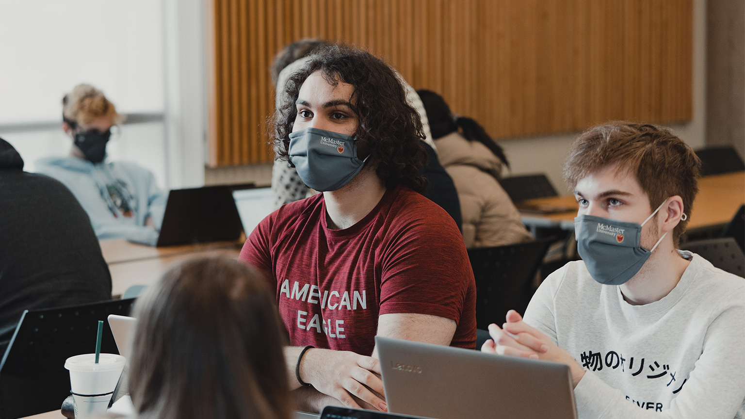 two students wearing McMaster face masks