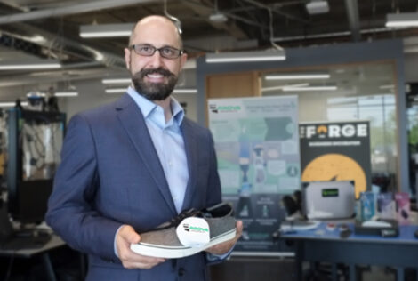 Matthew Rosato holds a shoe with the Prova Innovations logo on it