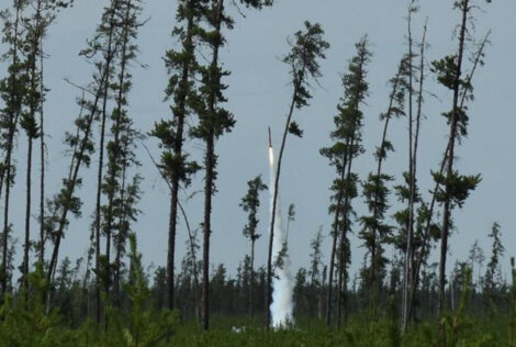 Mac Eng Rocketry Team's rocket launching into the sky among a line of trees