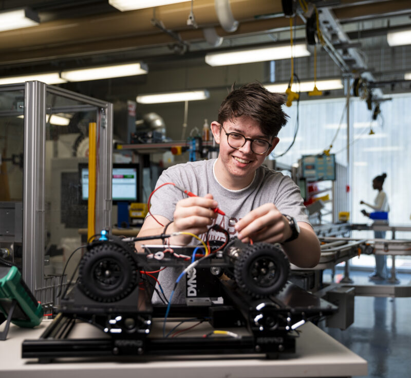 Tyler Lounsbury of the Remote Controlled (RC) Car Club works on a remote control car in the learning factory