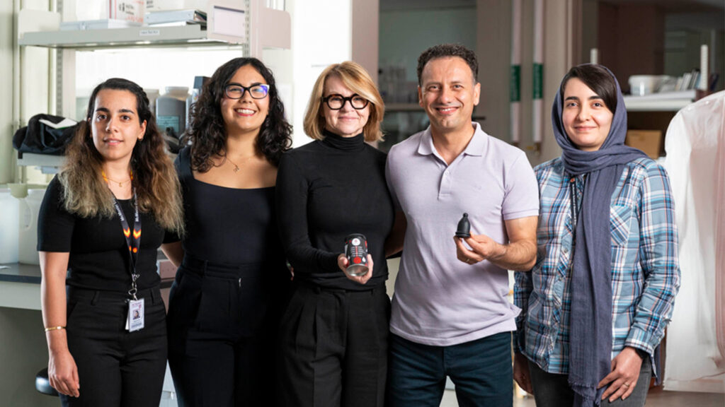 BFree research team pose together holding the period cup