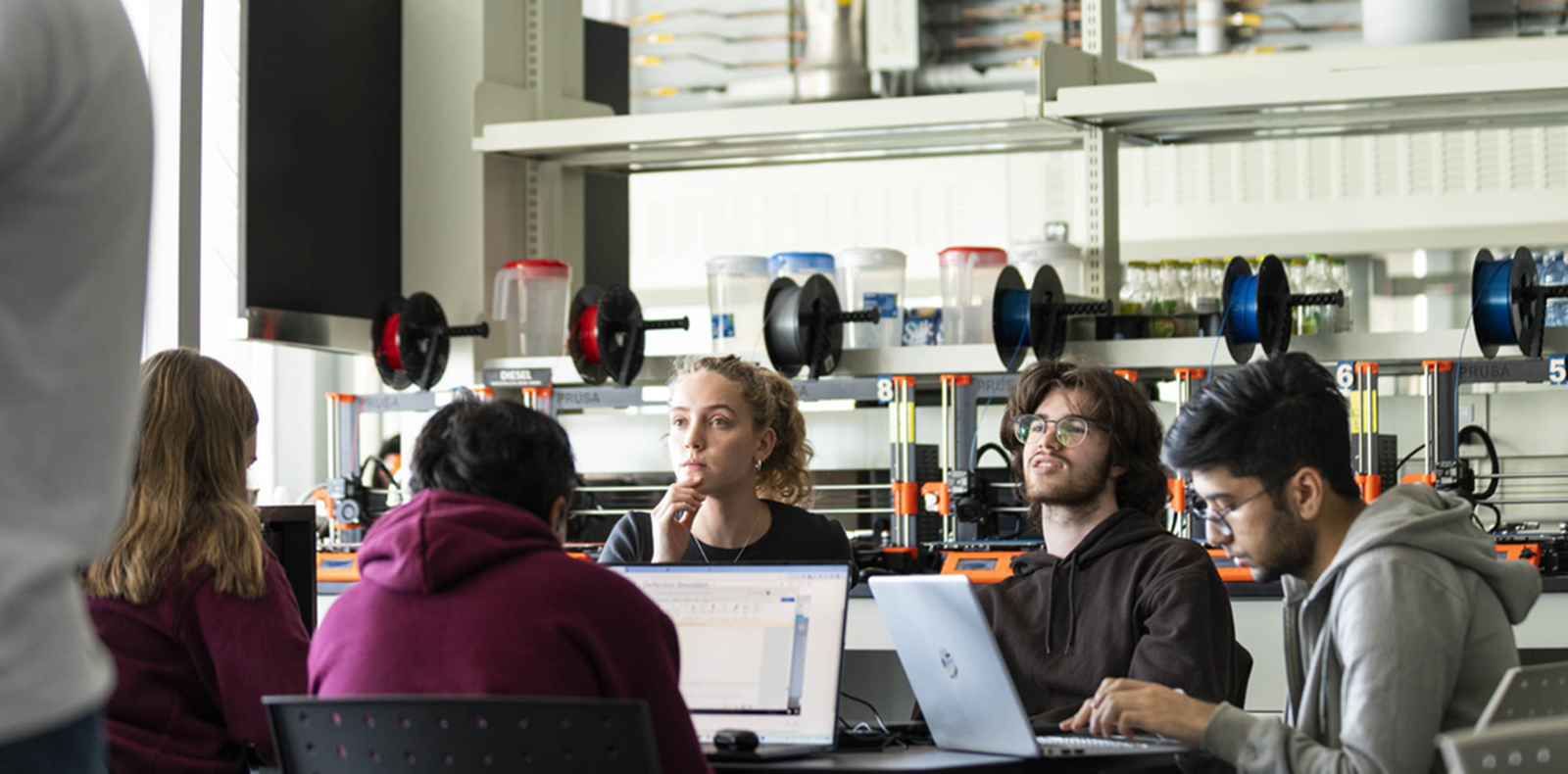 Students around a table in a classroom