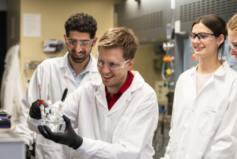 Students and professor working in lab