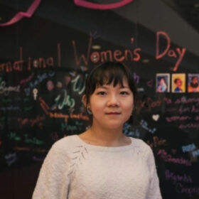 Picture of Mia in front of international women's day board