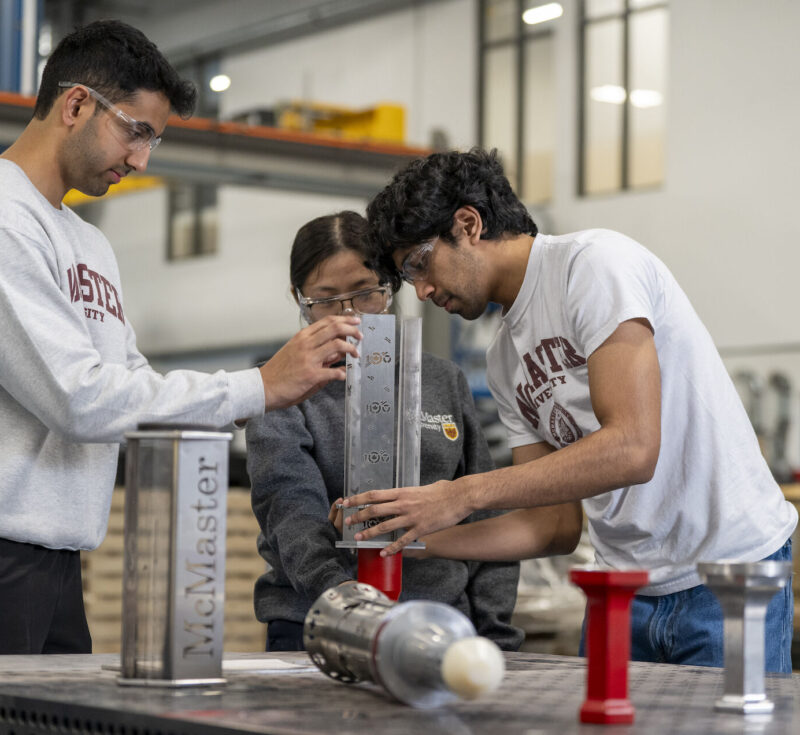 three students working on a torch.