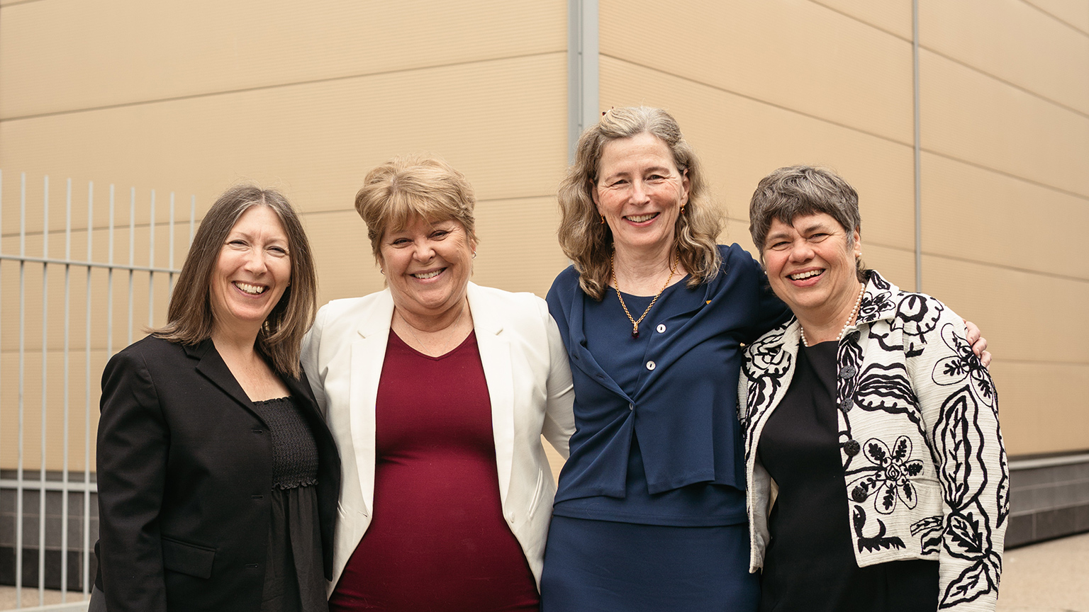 Jane Goodyer, Heather Sheardown, Mary Wells and Suzanne Kresta pose together with their arms around each other