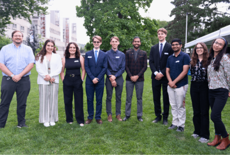 group of people posing side by side on a field.