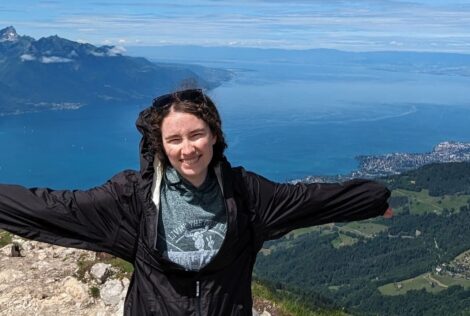 A woman standing on a mountain in Switzerland.