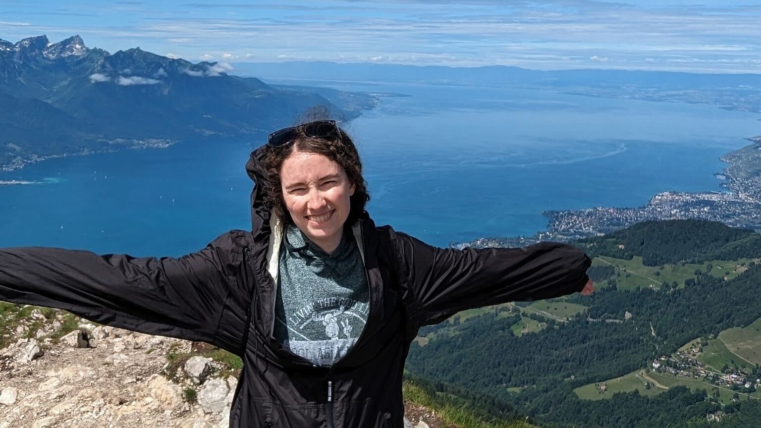 A woman standing on a mountain in Switzerland.