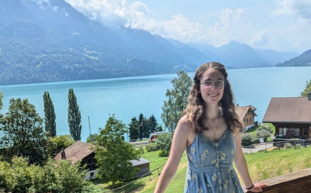 girl posing in front of a lake. 