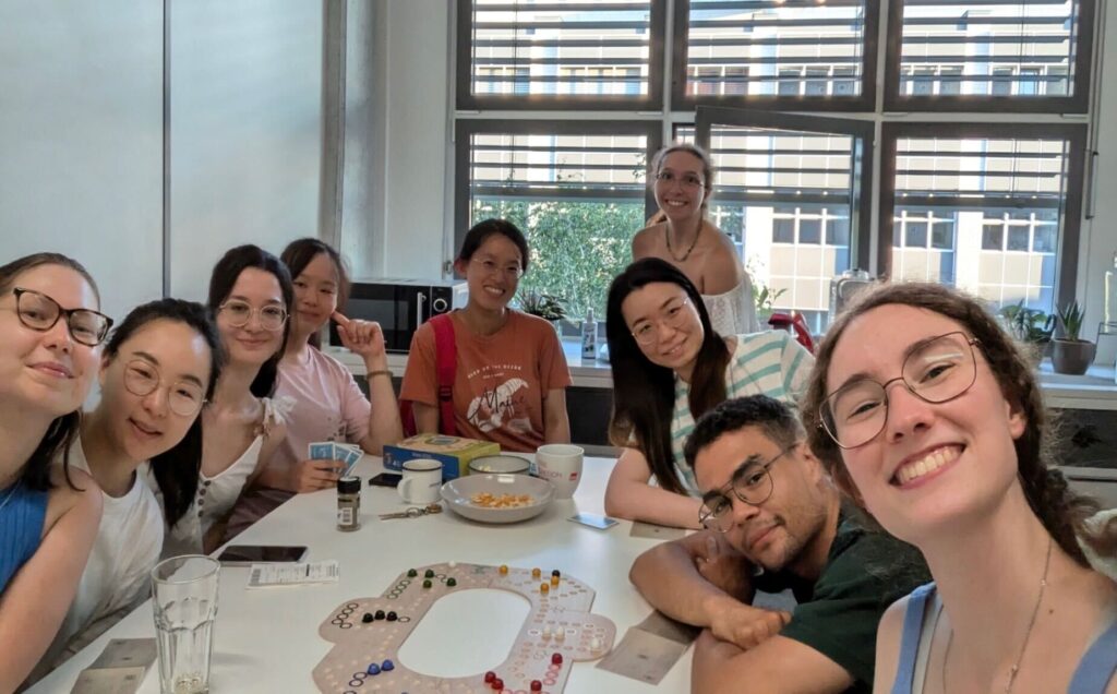 group of students around a table playing board games. 