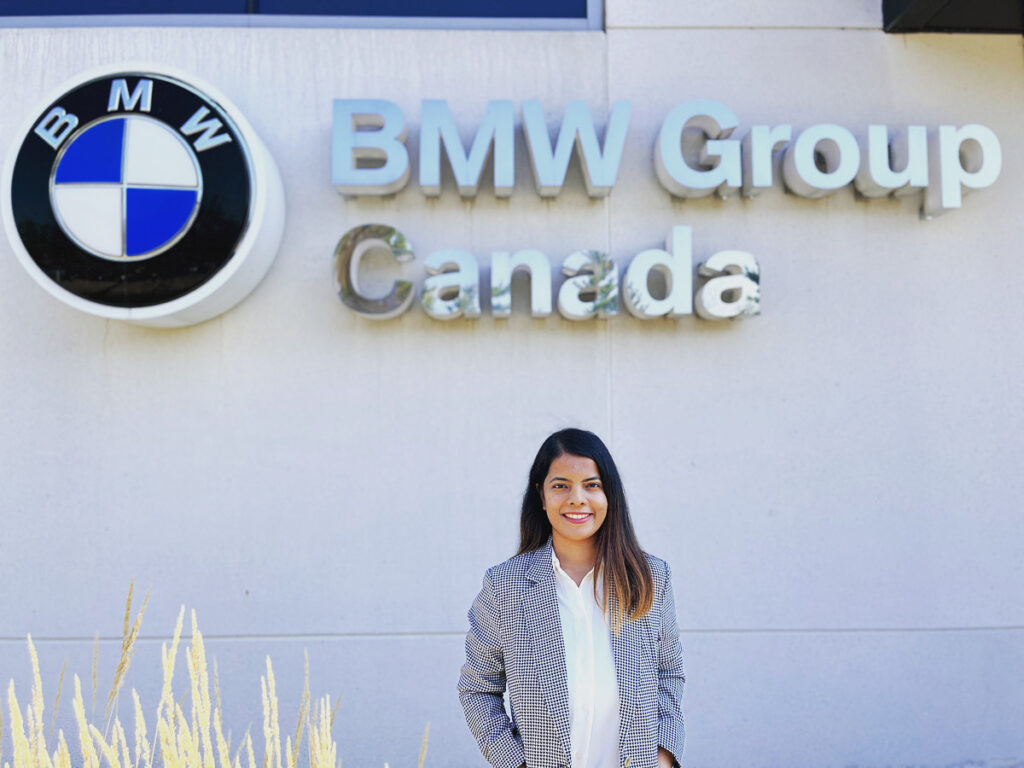 Pooja Gujral standing in front of BMW sign