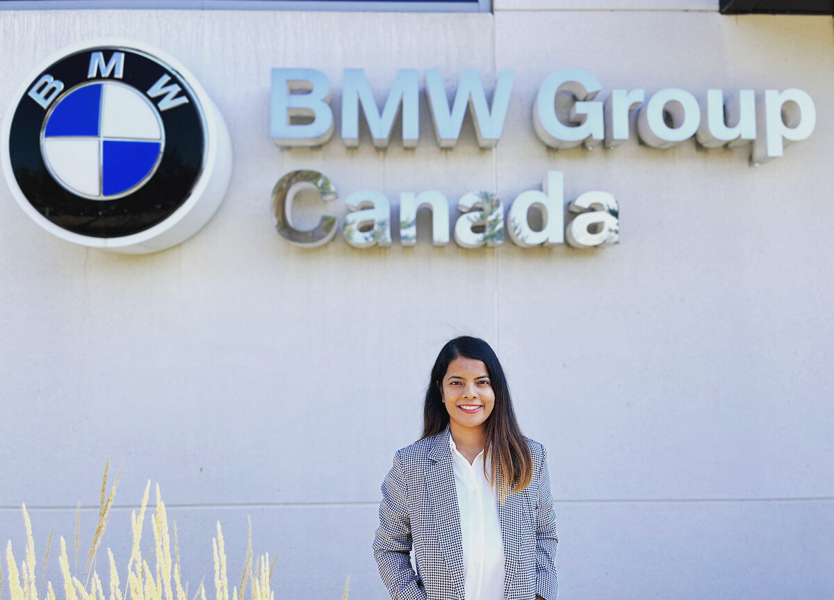 Pooja Gujral standing in front of BMW sign