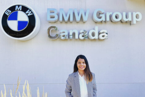 Pooja Gujral standing in front of BMW sign