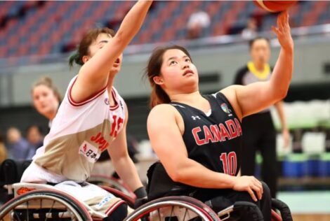 Puisand Lai playing wheelchair basketball