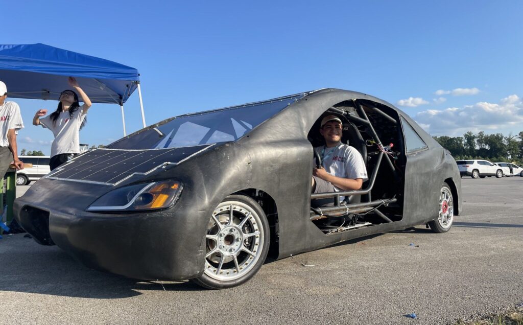 McMaster Solar Car member sitting inside car