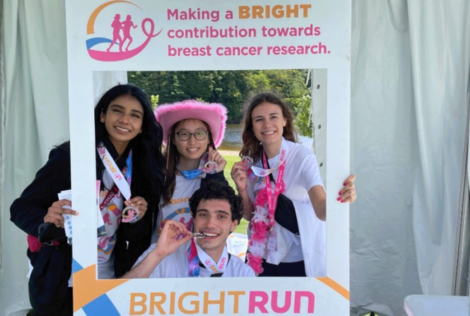 photo of students posing with a cutout of a sign.