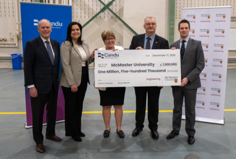 Candu and McMaster leadership standing with a large cheque